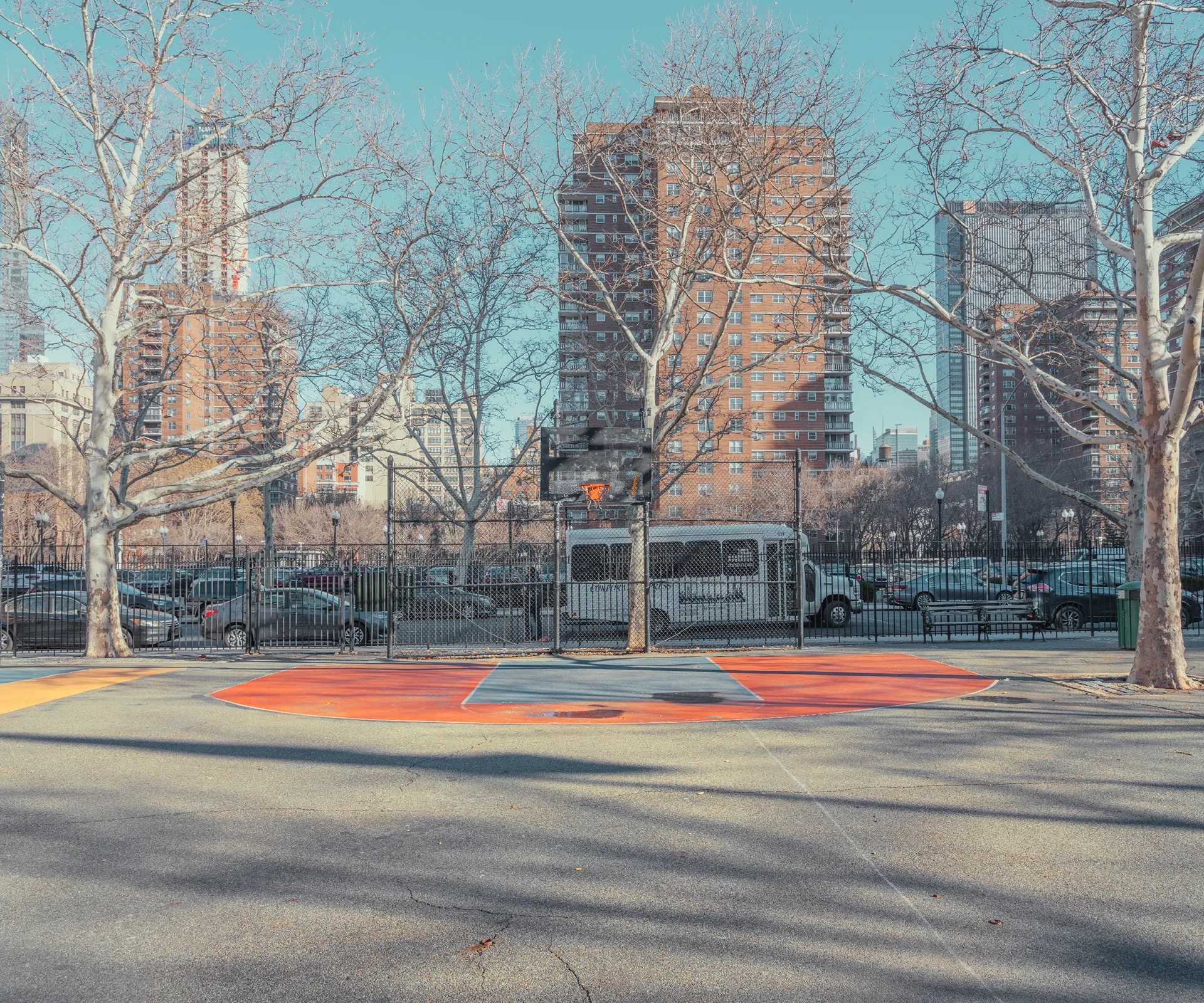 Quiet basketball court framed by trees and city buildings — limited edition fine art print by Ludwig Favre Quiet basketball court framed by trees and city buildings — limited edition fine art print by Ludwig Favre