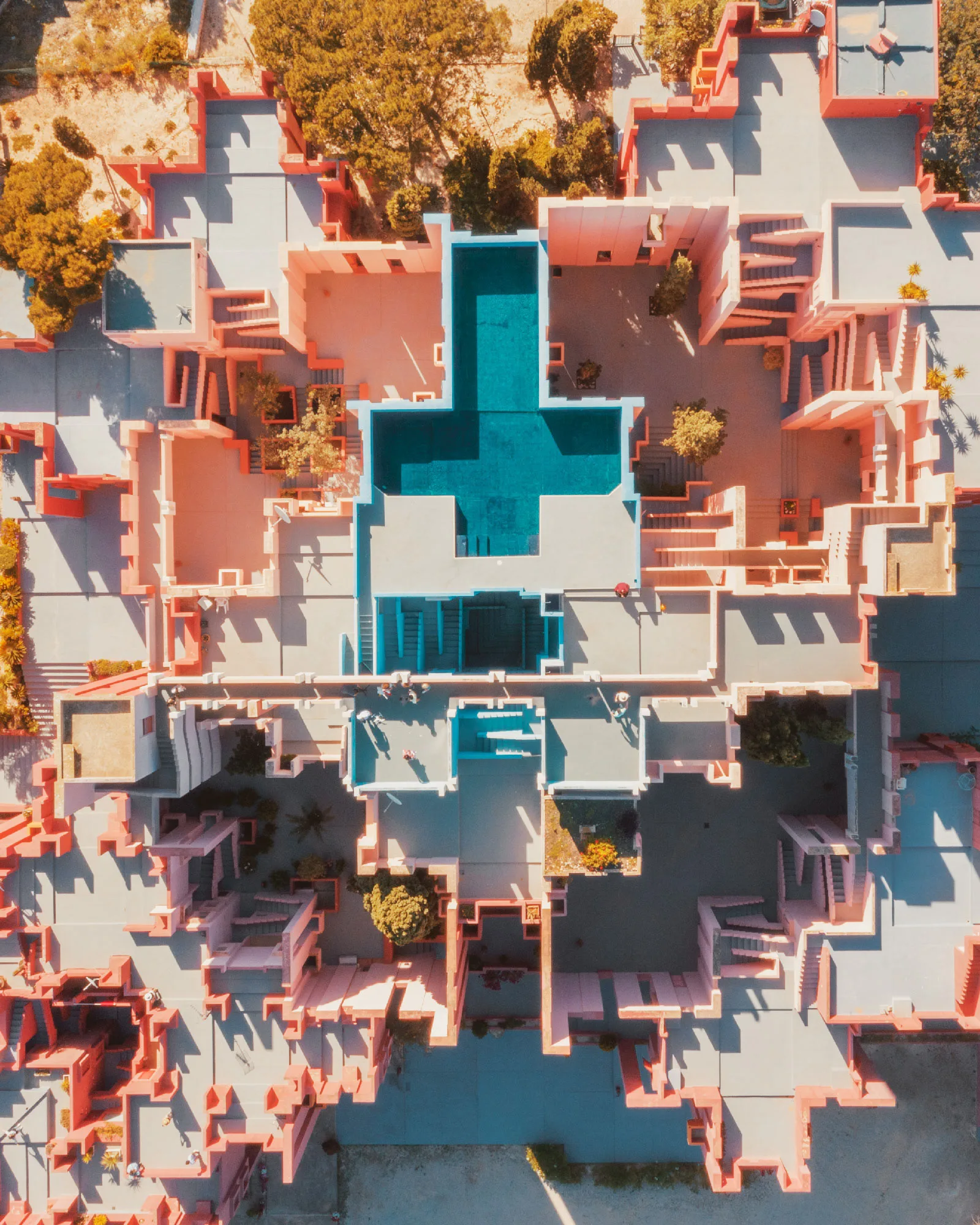 Aerial view of a turquoise swimming pool within a terracotta building complex — limited edition fine art print by Ludwig Favre Aerial view of a turquoise swimming pool within a terracotta building complex — limited edition fine art print by Ludwig Favre