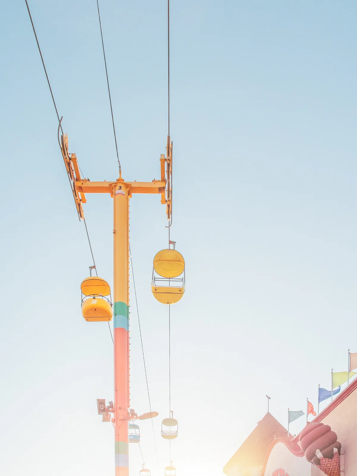 Aerial tramway station with suspended cabins, warm light — limited edition fine art print by Ludwig Favre Aerial tramway station with suspended cabins, warm light — limited edition fine art print by Ludwig Favre