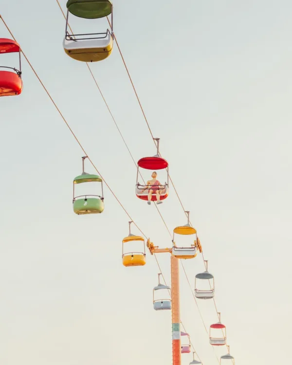 Colorful gondola cars suspended above Santa Cruz amusement park — limited edition fine art print by Ludwig Favre