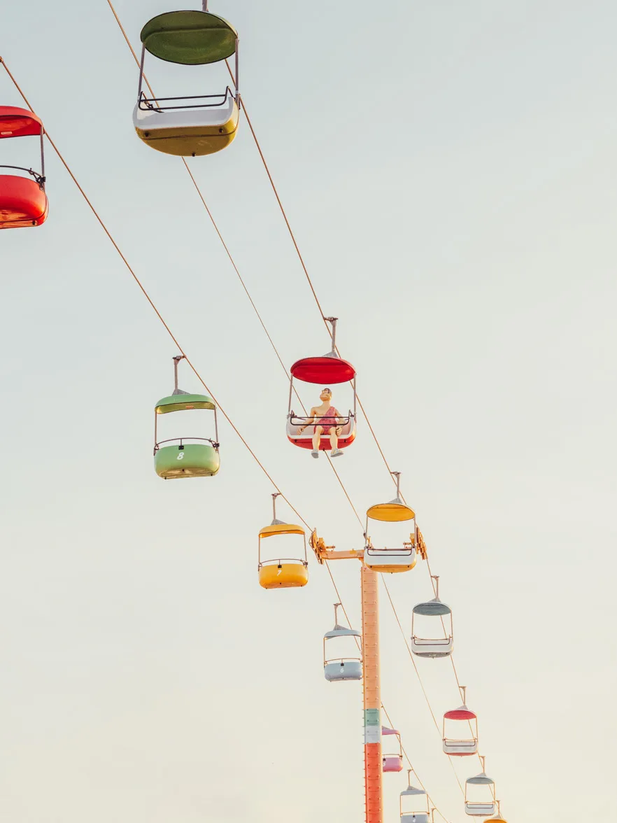 Colorful gondola cars suspended above Santa Cruz amusement park — limited edition fine art print by Ludwig Favre