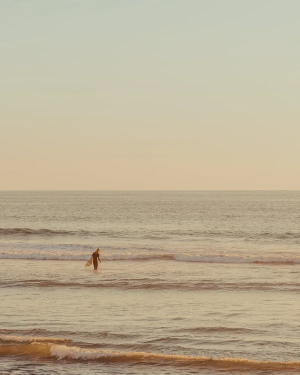 Lone figure walking on a California beach bathed in golden light — limited edition fine art print by Ludwig Favre