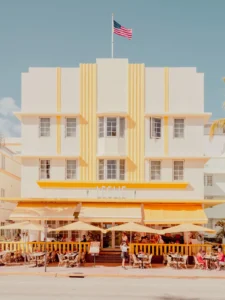 Art Deco Leslie Hotel on Miami Beach, Florida, with diners and palm trees, fine art print by Ludwig Favre