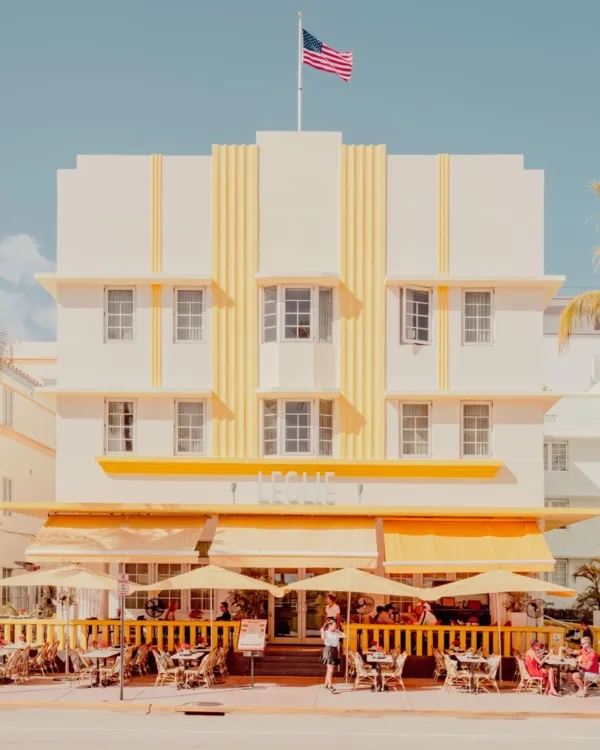 Art Deco Leslie Hotel in Miami Beach with outdoor seating and palm trees — limited edition fine art print by Ludwig Favre