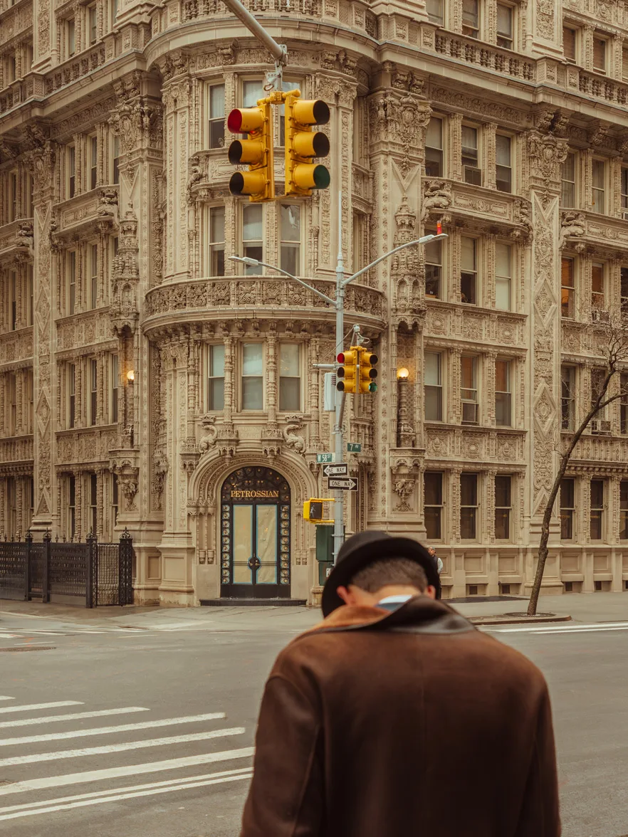 Man in bowler hat crossing a street with historic New York architecture — limited edition fine art print by Ludwig Favre