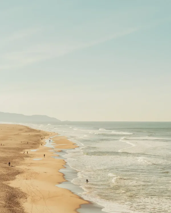 Wide view of Ocean Beach, San Francisco with waves and a lone figure — limited edition fine art print by Ludwig Favre