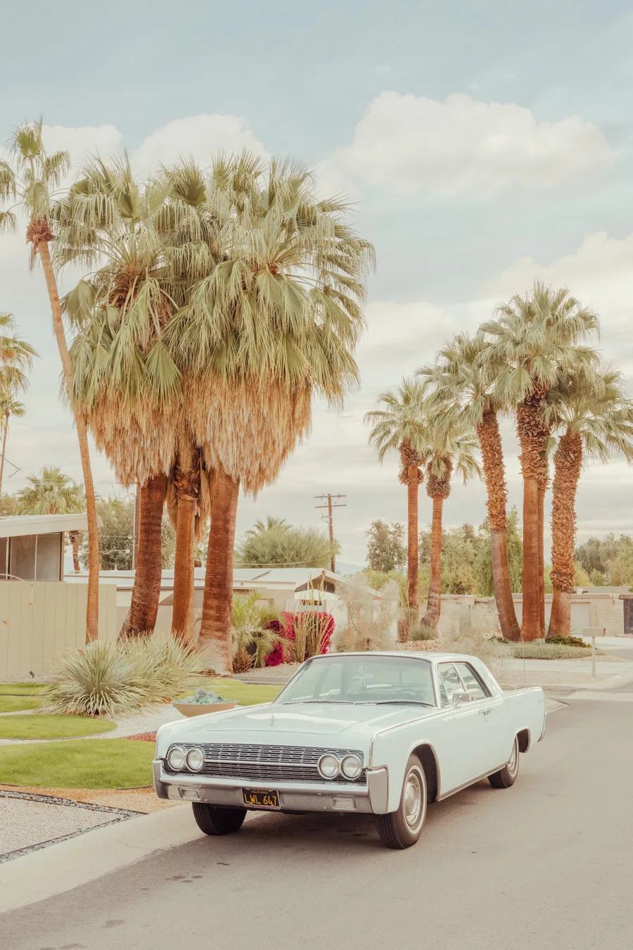 Vintage white Lincoln Continental parked on a Palm Springs street — limited edition fine art print by Ludwig Favre