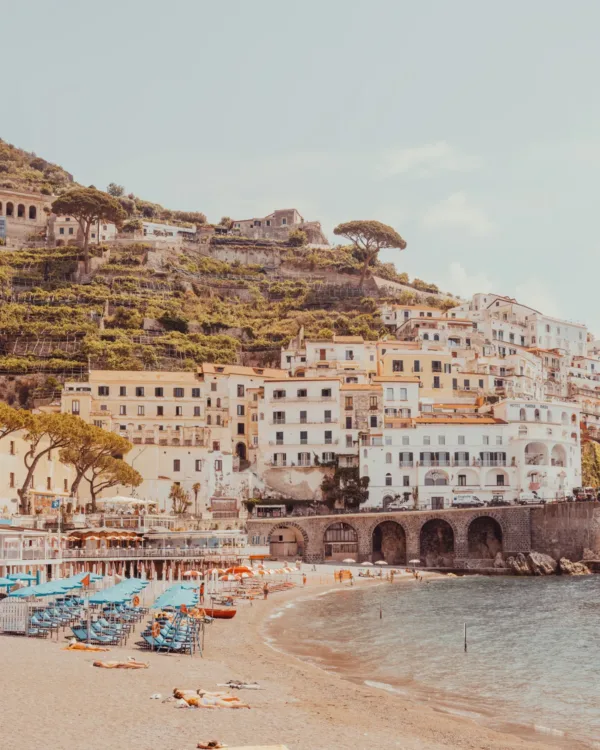 Terraced houses overlooking a sandy Positano beach and turquoise sea — limited edition fine art print by Ludwig Favre