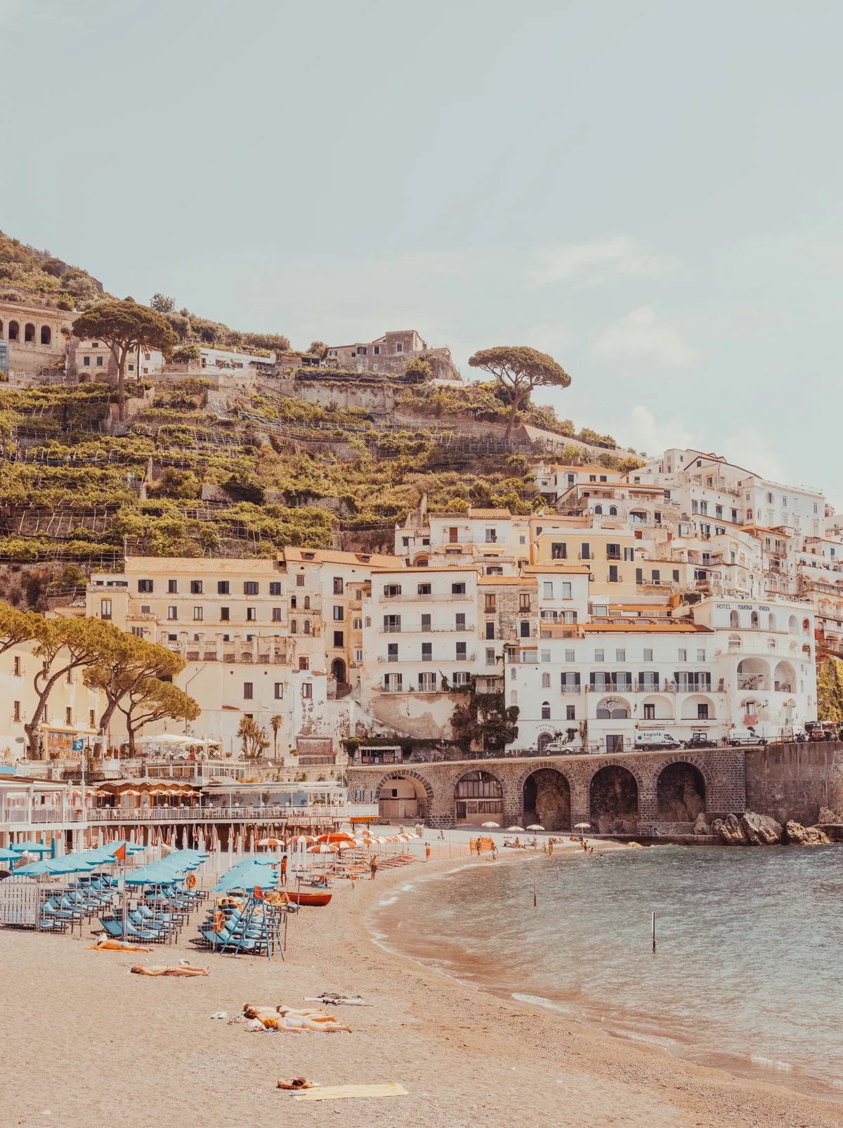 Terraced houses overlooking a sandy Positano beach and turquoise sea — limited edition fine art print by Ludwig Favre
