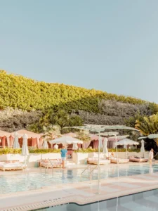 Strawberry Pool at Miami Beach with pastel umbrellas and lounge chairs, fine art print by Ludwig Favre