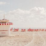 White lifeguard stand on Miami Beach under a cloudy sky and turquoise water — limited edition fine art print by Ludwig Favre