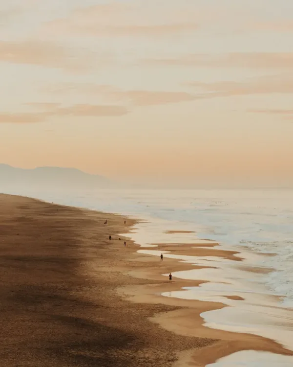 Ocean Beach in San Francisco at dawn, with soft light and distant hills — limited edition fine art print by Ludwig Favre
