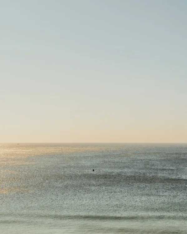 Gentle waves and a calm ocean under a pale blue sky in Santa Barbara — limited edition fine art print by Ludwig Favre
