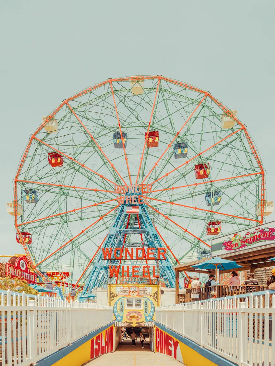 Vintage Coney Island Ferris wheel with pastel hues and classic signage — limited edition fine art print by Ludwig Favre