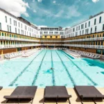 Aerial view of a turquoise Paris swimming pool with Art Deco architecture — limited edition fine art print by Ludwig Favre