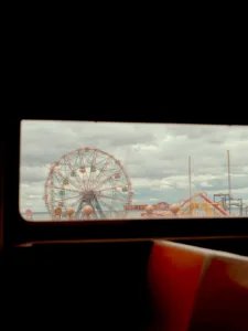 View of Coney Island Ferris wheel and amusement park through — limited edition fine art print by Ludwig Favre