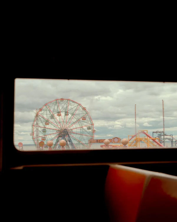 View of Coney Island Ferris wheel and amusement park through — limited edition fine art print by Ludwig Favre