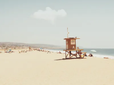 Wooden lifeguard tower on Balboa Island beach with a clear blue sky, fine art print by Ludwig Favre