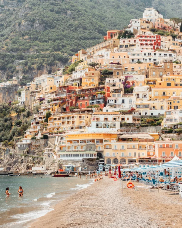 Colorful Positano coastline with tiered houses, sandy beach — limited edition fine art print by Ludwig Favre