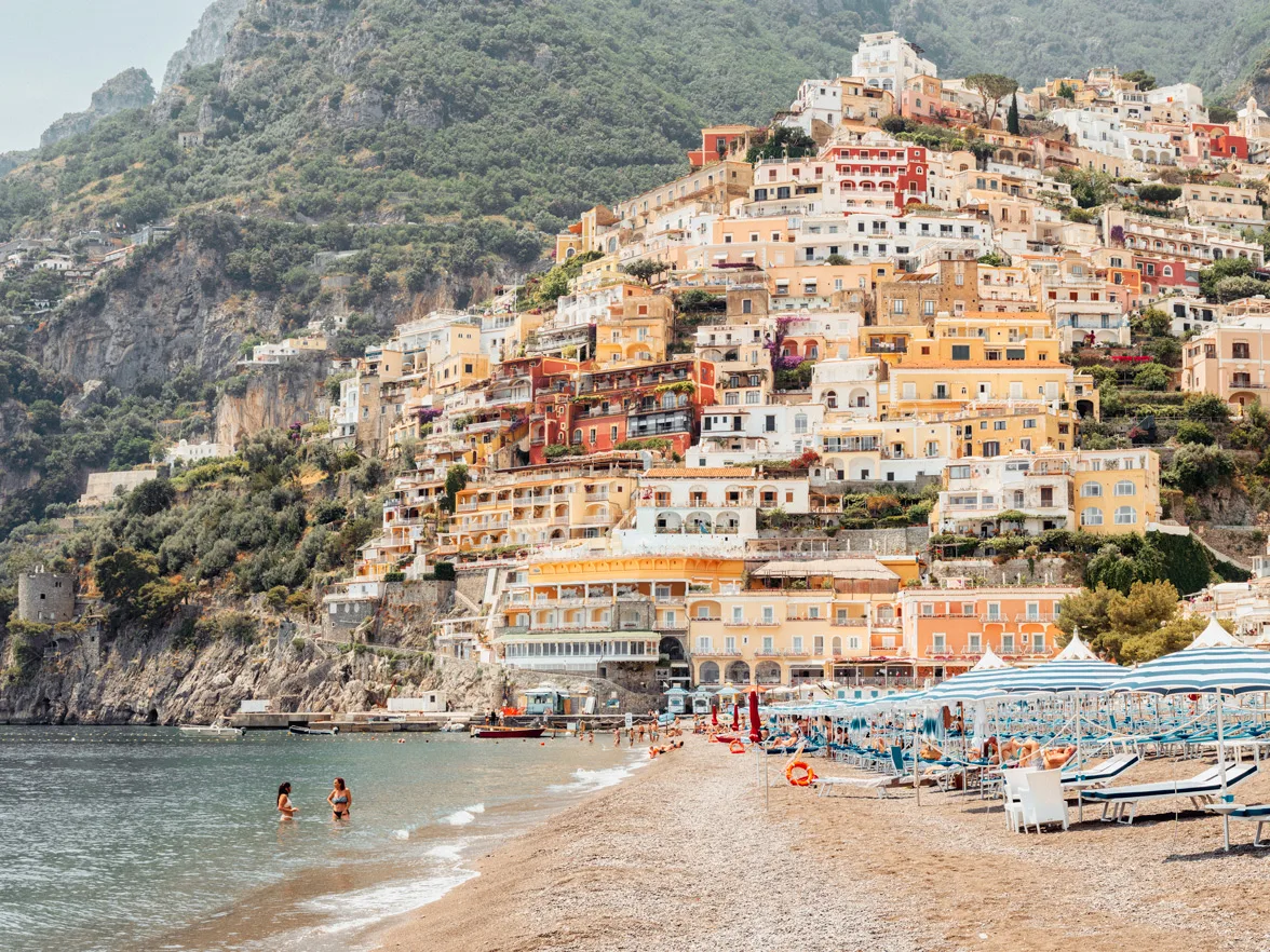 Colorful Positano coastline with tiered houses, sandy beach — limited edition fine art print by Ludwig Favre