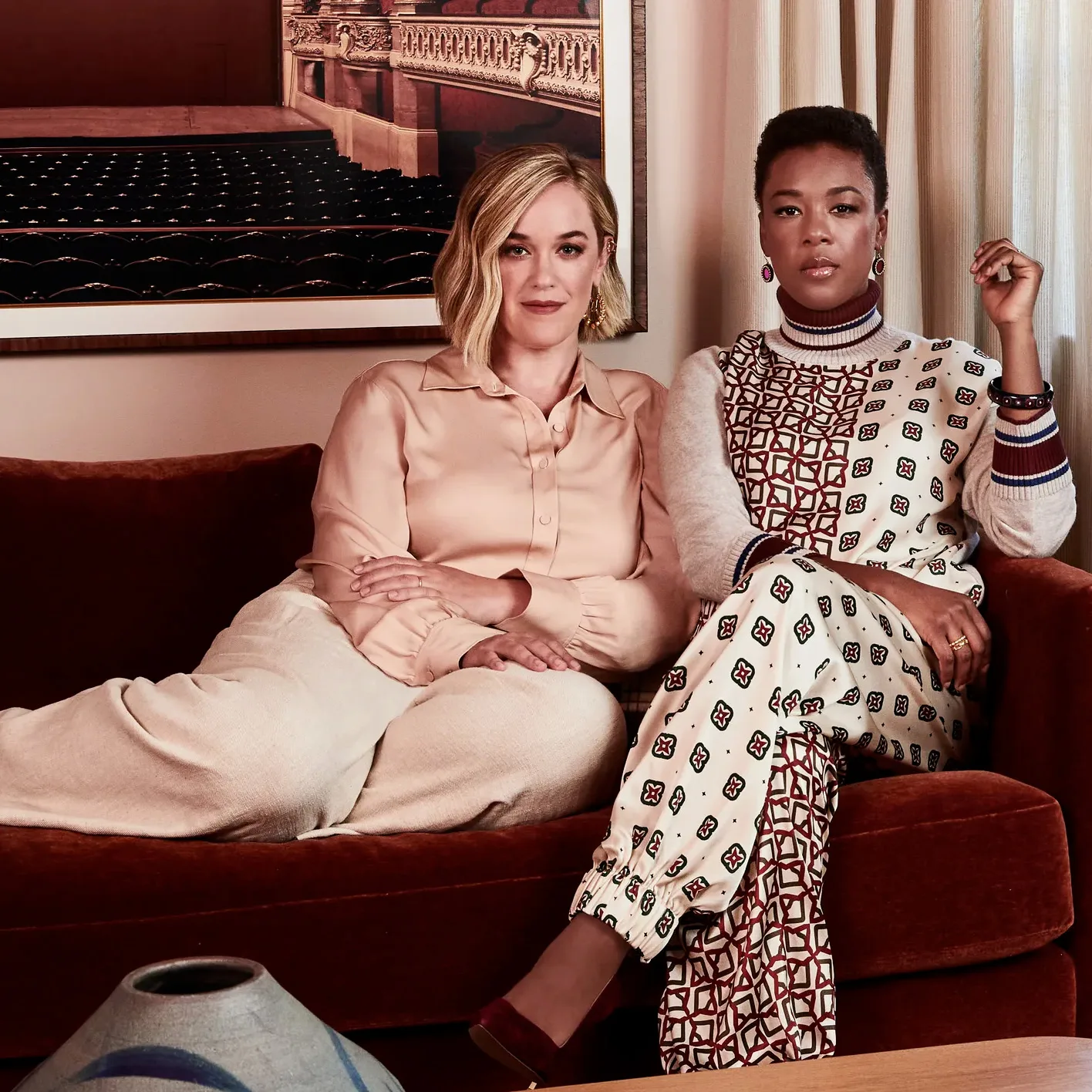 Samira Wiley and Lauren Morelli at home, with Ludwig Favre's Palais Garnier print on the wall, interior design by Stefani Stein, featured in Architectural Digest.