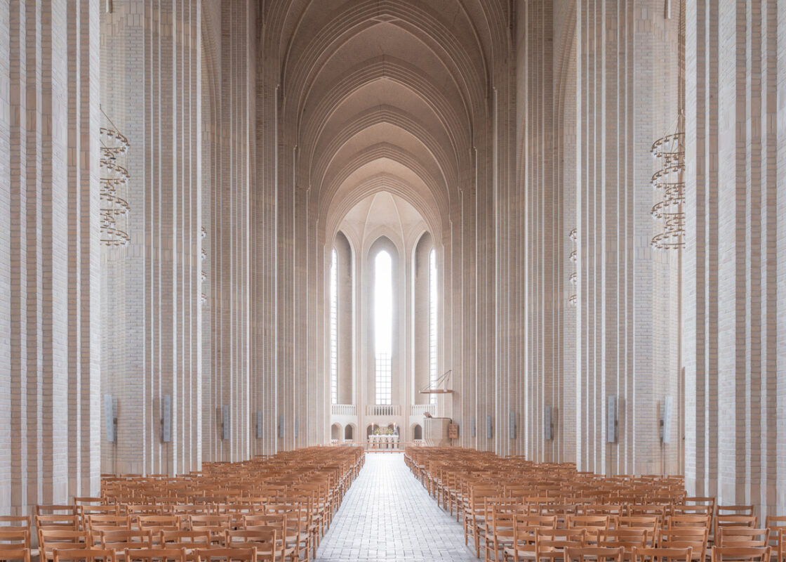 Minimalist interior of Grundtvigs Kirke in Copenhagen with tall columns and soft natural light, limited edition fine art print by Ludwig Favre
