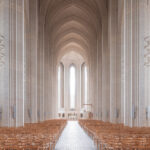 Minimalist interior of Grundtvigs Kirke in Copenhagen with tall columns and soft natural light, limited edition fine art print by Ludwig Favre