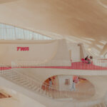 TWA Flight Center interior at JFK, New York: curved concrete, red carpet and TWA sign — limited edition fine art print by Ludwig Favre