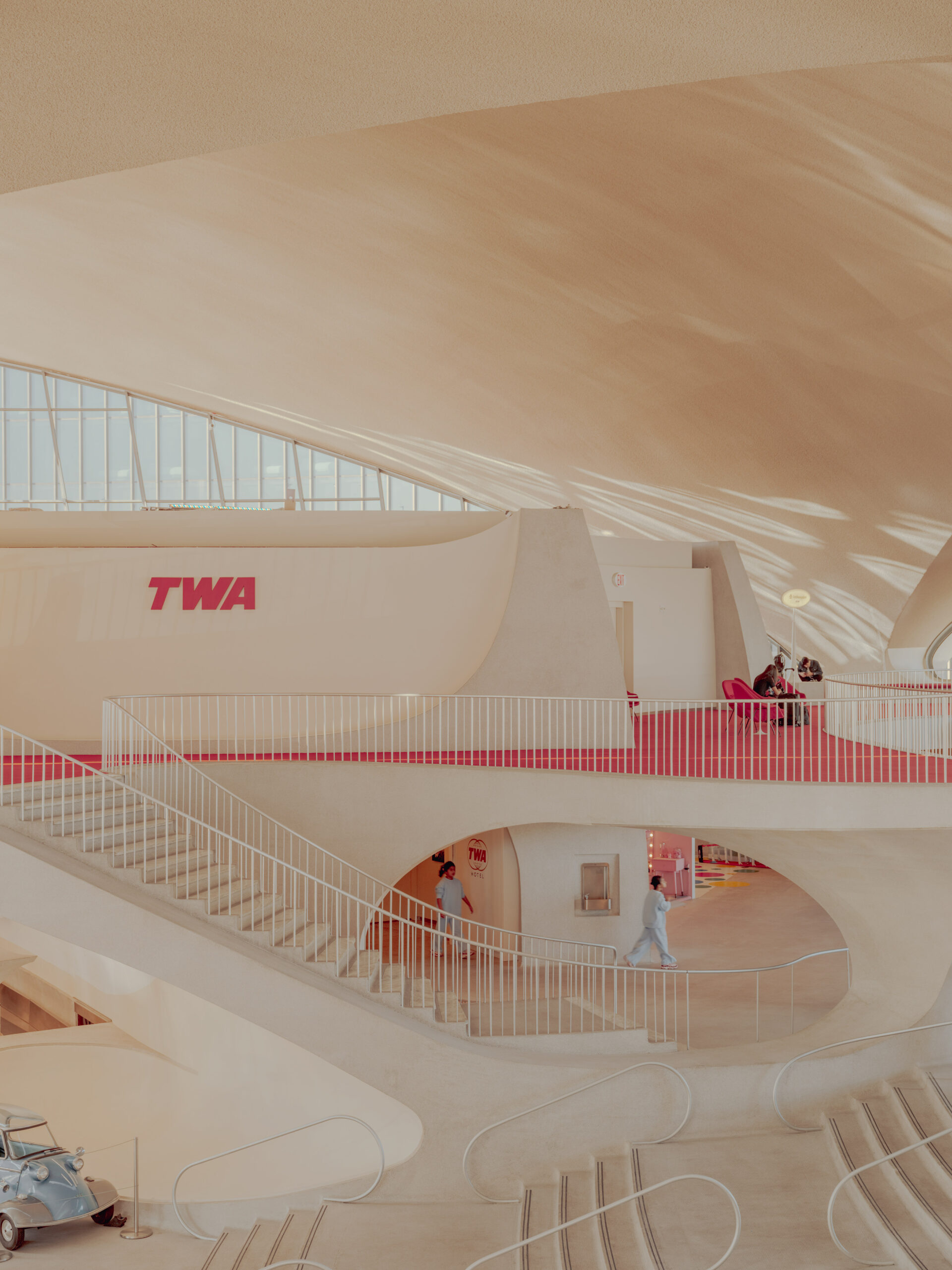 _DSF7155 TWA Flight Center interior at JFK, New York: curved concrete, red carpet and TWA sign — limited edition fine art print by Ludwig Favre