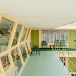 Green chairs on a mint-green balcony of the Caribbean Motel, Wildwood Crest, limited edition fine art photograph by Ludwig Favre
