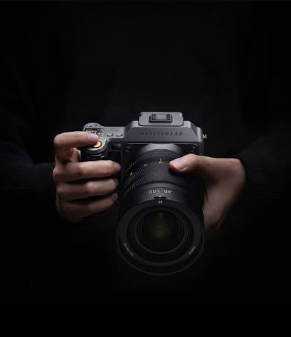 Photographer holding a Fujifilm GFX medium format camera