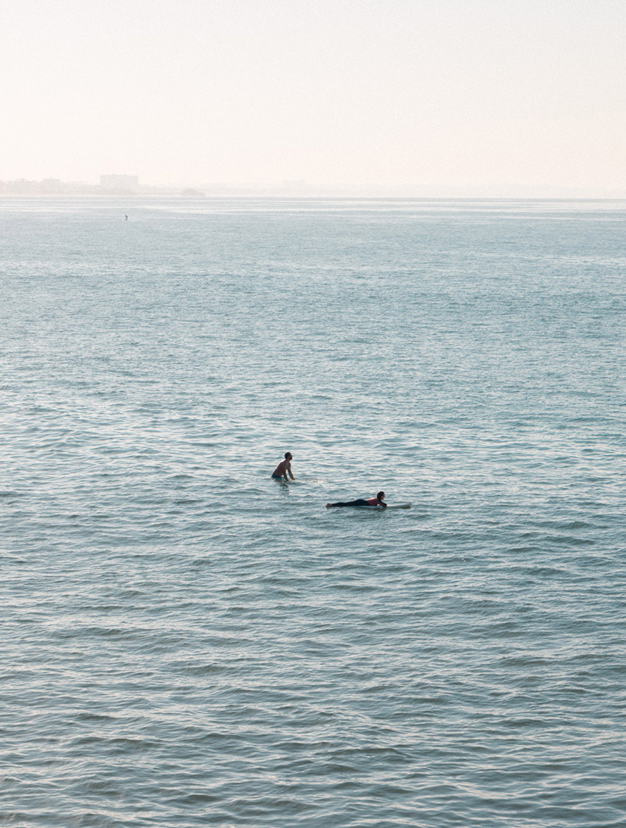 Fine art photography for sale by Ludwig Favre: two surfers on the Pacific Ocean, Los Angeles