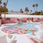 Pink motel pool with donut floats and palm trees, Palm Springs, limited edition fine art photograph by Ludwig Favre