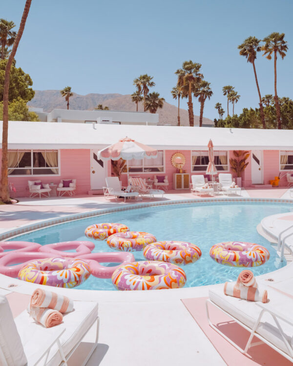 Pink motel pool with donut floats and palm trees, Palm Springs, limited edition fine art photograph by Ludwig Favre