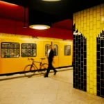 A blurred man in dark clothes pulls a bicycle past a yellow subway train in a red-and-yellow tiled Berlin station.
