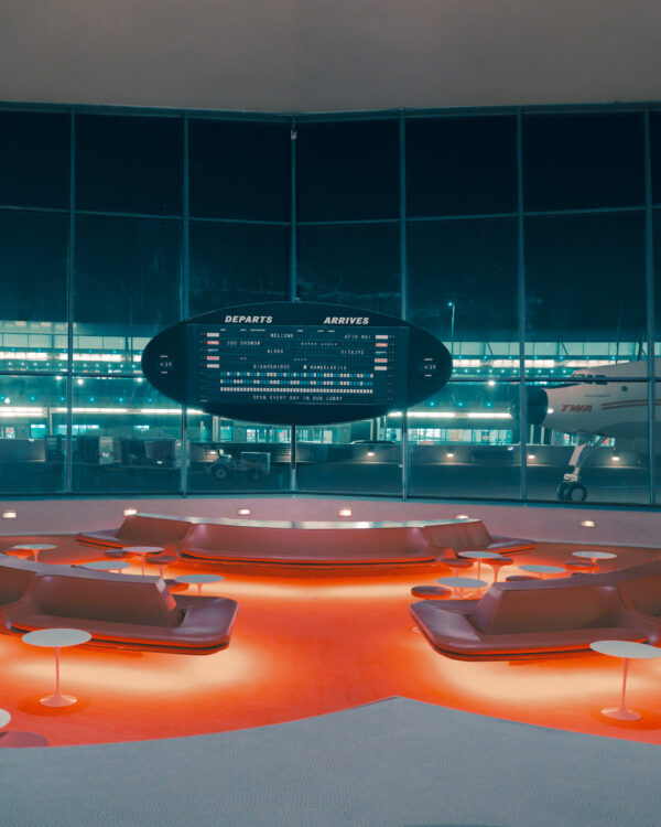 Red curved lounge seating and flight board at TWA Hotel New York print, fine art print by Ludwig Favre